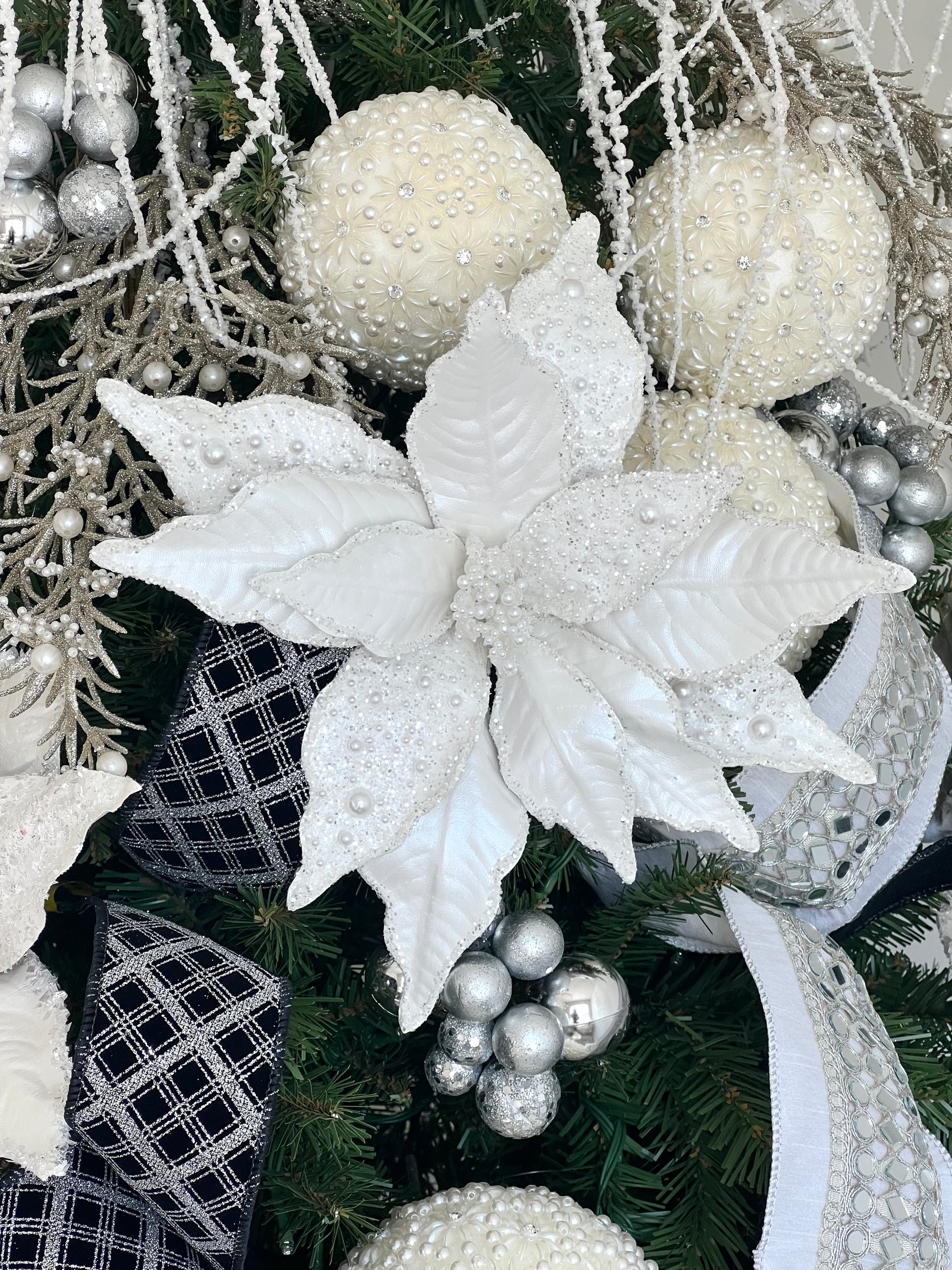 White poinsettia stem with pearl beads dusted across the petals. Glam Christmas decor.