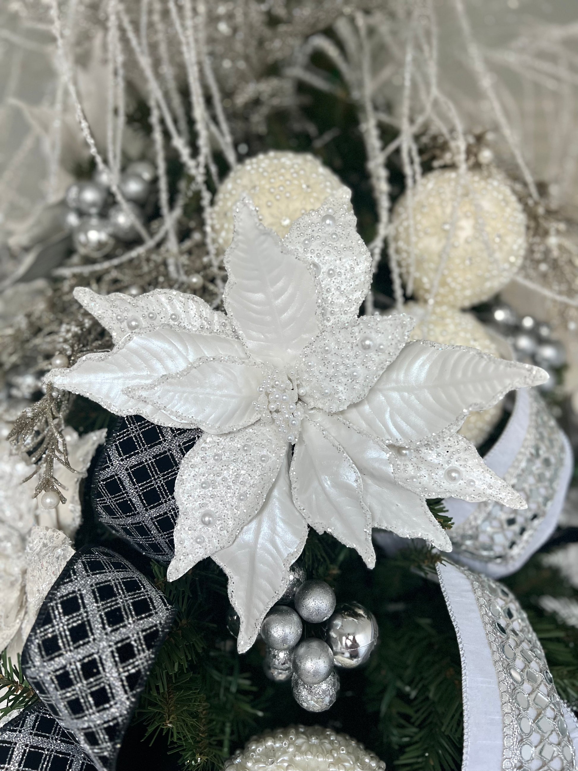 White poinsettia stem with pearl beads dusted across the petals.  Glam Christmas decor.